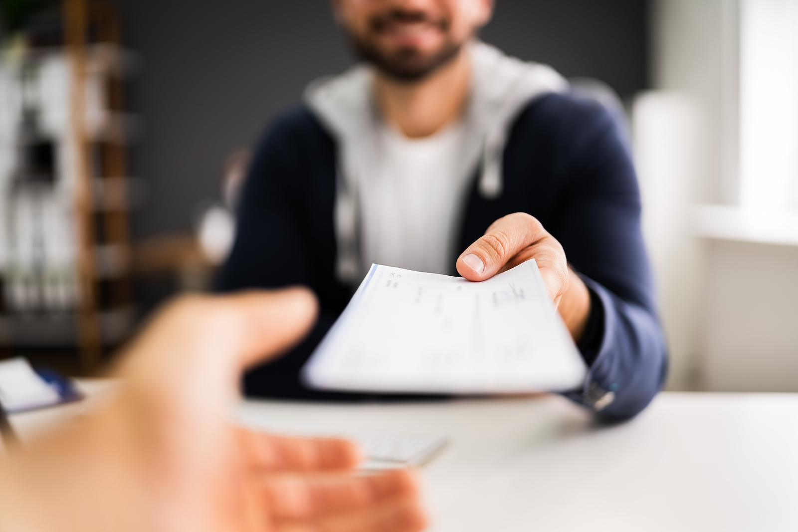 bigstock Man Giving Payroll Compensatio 393368195