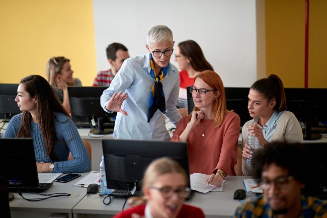 bigstock Female professor inspecting th 385270145